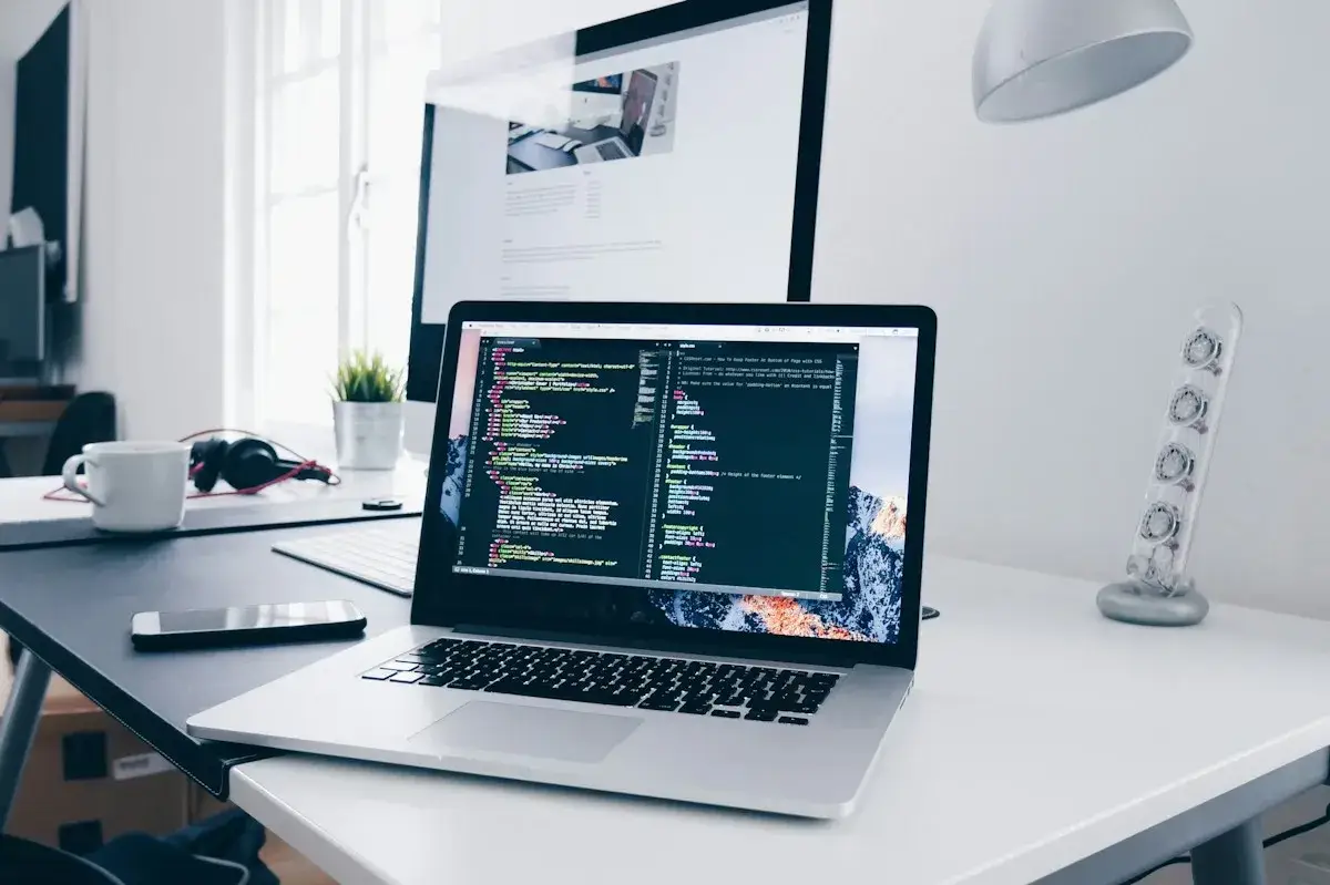 Laptop and development workspace illustrating website production